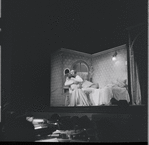 Larry Kert and Carol Lawrence kneeling [embracing] in bedroom scene from the stage production West Side Story