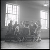 Jean Rosenthal [?], Leonard Bernstein, Jerome Robbins [sitting], Arthur Laurents, Stephen Sondheim, Irene Sharaff, Hal Prince, Robert E. Griffith, and Sylvia Drulie in rehearsal for the stage production West Side Story
