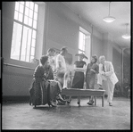 Jean Rosenthal[?], Leonard Bernstein, Arthur Laurents (obscured), Jerome Robbins (foreground), Stephen Sondheim (obscured), Irene Sharaff, Sylvia Drulie, and Robert E. Griffith in rehearsal for the stage production West Side Story
