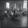 Dancers rest (Jerome Robbins visible in mirror) during rehearsal for the stage production West Side Story