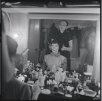 Irene Sharaff and Lee Theodore (a.k.a. Lee Becker) in the dressing room (photographer Martha Swope visible in mirror holding camera) during the stage production West Side Story