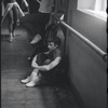 Lee Theodore (a.k.a. Lee Becker) resting and Chita Rivera seen approaching in background during rehearsal for the stage production West Side Story 