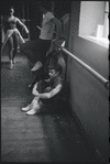 Lee Theodore (a.k.a. Lee Becker) resting and Chita Rivera seen approaching in background during rehearsal for the stage production West Side Story 