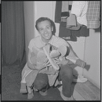 Larry Kert holding sneakers during opening night party at Roseland for the stage production West Side Story