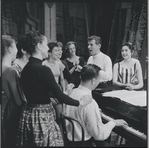 Chita Rivera, Stephen Sondheim, Leonard Bernstein, Carol Lawrence and other cast members around piano during rehearsal for the stage production West Side Story