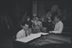 Stephen Sondheim, Leonard Bernstein, and cast around piano in rehearsal for the stage production West Side Story