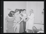 Unidentified actors receiving vaccinations in publicity photograph related to the stage production West Side Story