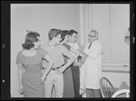 Unidentified actors receiving vaccinations in publicity photograph related to the stage production West Side Story