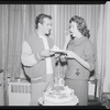 Publicity photographs of actors celebrating backstage the first anniversary for the stage production West Side Story