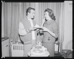 Publicity photographs of actors celebrating backstage the first anniversary for the stage production West Side Story