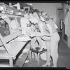 Publicity photographs of actors celebrating backstage the first anniversary for the stage production West Side Story