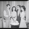 Publicity photographs of actors celebrating backstage the first anniversary for the stage production West Side Story