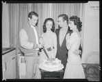 Publicity photographs of actors celebrating backstage the first anniversary for the stage production West Side Story