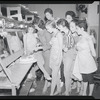 Publicity photographs of actors celebrating backstage the first anniversary for the stage production West Side Story