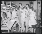 Publicity photographs of actors celebrating backstage the first anniversary for the stage production West Side Story