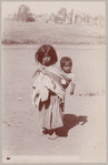 Mexican woman carrying child