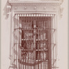 Woman peering out from a barred window