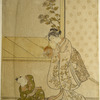 A woman holding up a demon mask to amuse her small son who sits upon the floor before her
