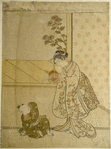 A woman holding up a demon mask to amuse her small son who sits upon the floor before her
