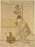 A woman holding up a demon mask to amuse her small son who sits upon the floor before her
