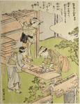 Women cleaning silkworm trays with a feather brush