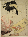 Large head and bust of a woman looking at a doll dressed to represent a boy dancing the Lion Dance (Shishi Odori)