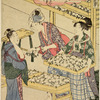 Women arranging cocoons in trays