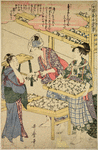 Women arranging cocoons in trays