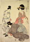 Two women dressing a youth for a game of football