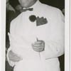 View of comedian Eddie Green, in a white jacket, speaking at an unidentified event