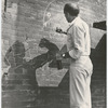 Jerome Robbins drawing with chalk on brick wall during West Side Story 1961 movie production