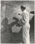 Jerome Robbins drawing with chalk on brick wall during West Side Story 1961 movie production