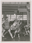 Pop Gates (at center in light color uniform) of the Dayton Rens, during a basketball game against the Anderson Packers