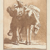 Man leaning against a laden horse