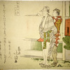 Two men walking, one carrying a box