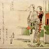 Two men walking, one carrying a box