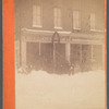 Group of people standing outside Gilbert G. Gaston store in snow scene, Steubenville, Ohio
