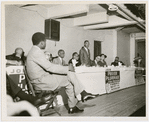 Dr. Martin Luther King, Jr., center, addressing a group of Harlem ministers in preparation for the Prayer Pilgrimage for Freedom to Washington, D.C