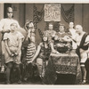 Raymond McKee (glasses), Juanita Fletcher, William Wadsworth (at table in dark toga) and unidentified others in the motion picture short Friends, Romans and Leo