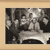 Roma group gathered around a table; King Kaslof at right