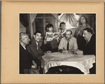 Roma group gathered around a table; King Kaslof at right