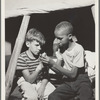 African American youth giving first aid to a white youth at Camp Nathan Hale, Southfields, New York