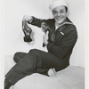 Gene Kelly in a sailor suit holding his well-worn pair of dancing shoes, no. 16