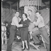 Cast members Robert Pagent (left) and John Raitt (right) with photographer Florence Vandamm (seated on horse) and unidentified woman