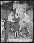 Cast members Robert Pagent (left) and John Raitt (right) with photographer Florence Vandamm (seated on horse) and unidentified woman