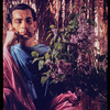 Hugh Laing in improvised costume with lilacs