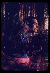 Hugh Laing in improvised costume with lilacs