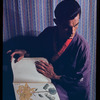 Hugh Laing in Japanese costume with chrysanthemum book