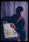 Hugh Laing in Japanese costume with chrysanthemum book
