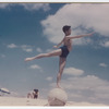Jerome Robbins at the beach balancing in arabesque on ball

